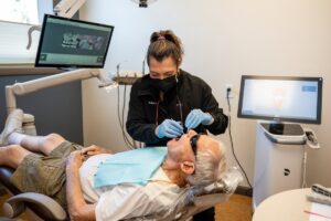 Tempe Dentist Dr. Amy Okun Treating a dental patients at her dental office